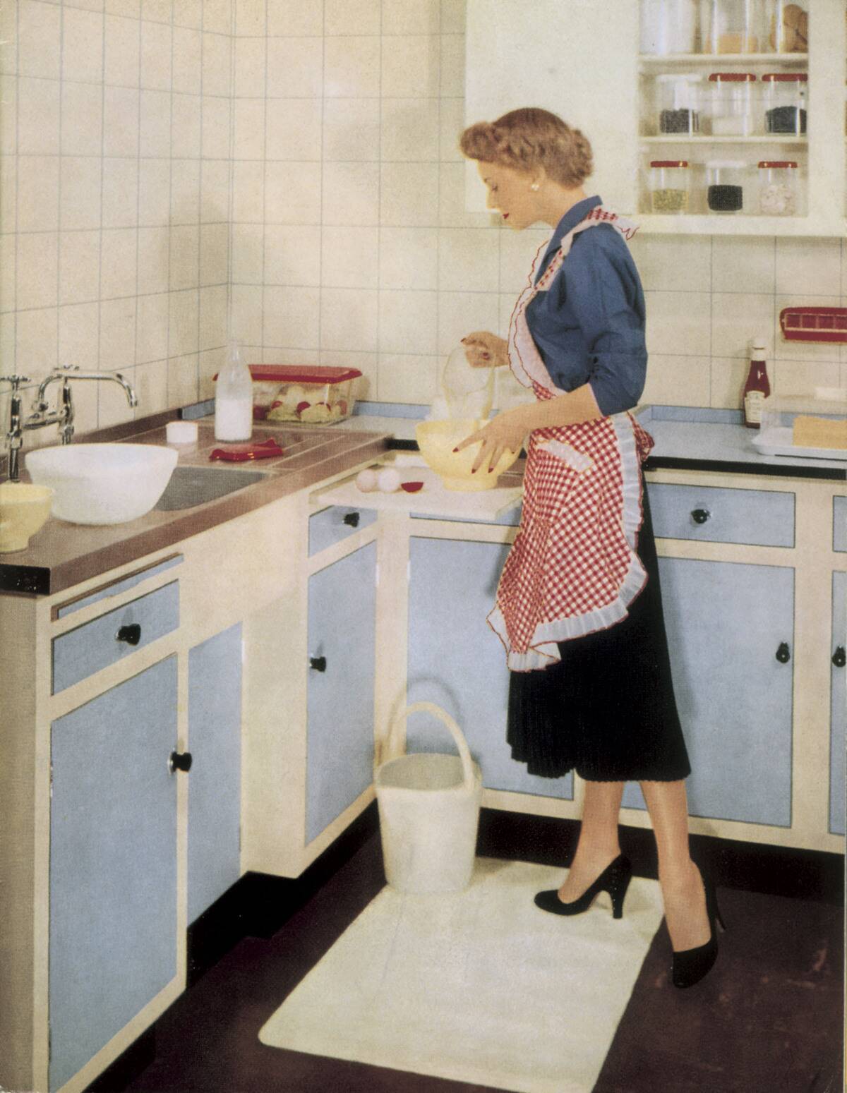 Woman in a fitted kitchen, 1955.