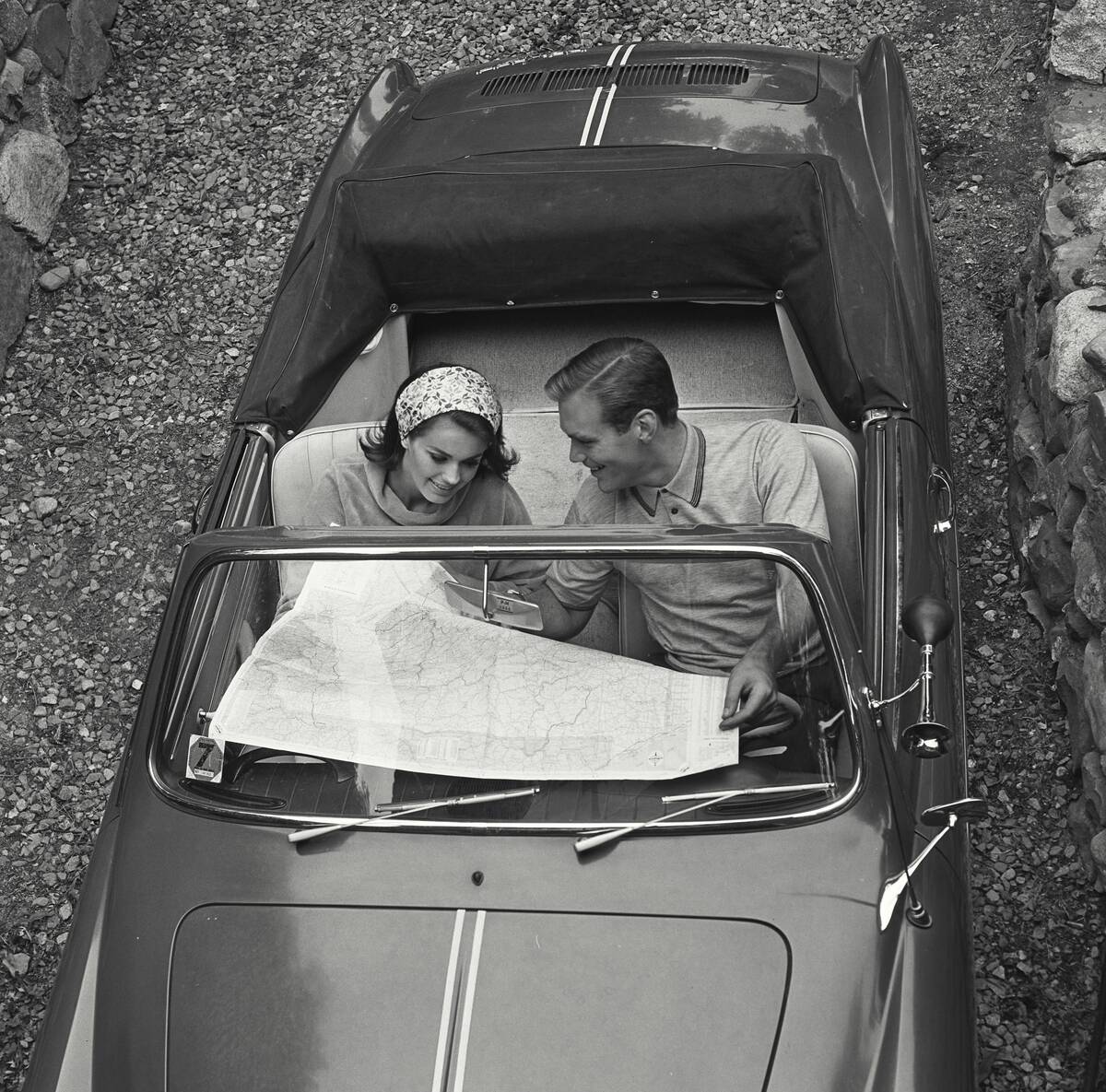 A couple looking at map in car