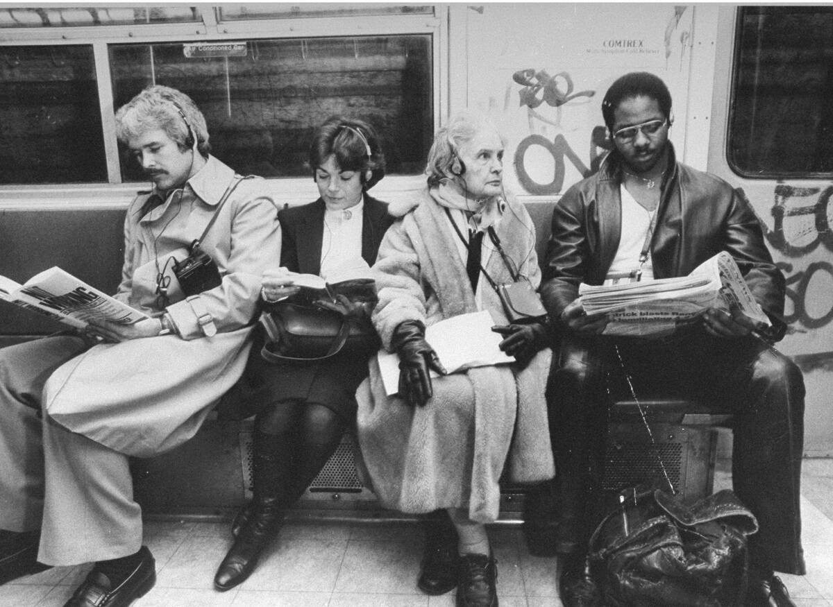 Four subway riders listening to their walkmans.