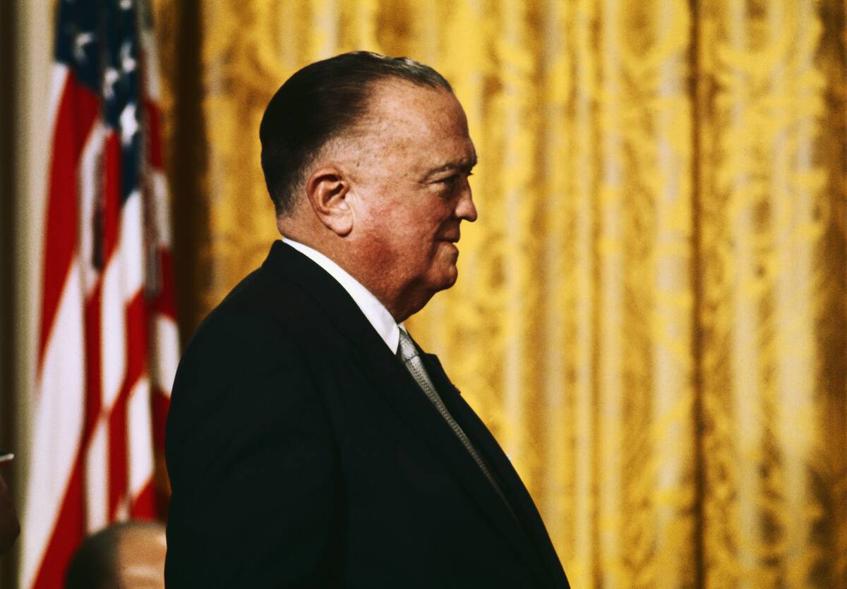J. Edgar Hoover Standing by Flag