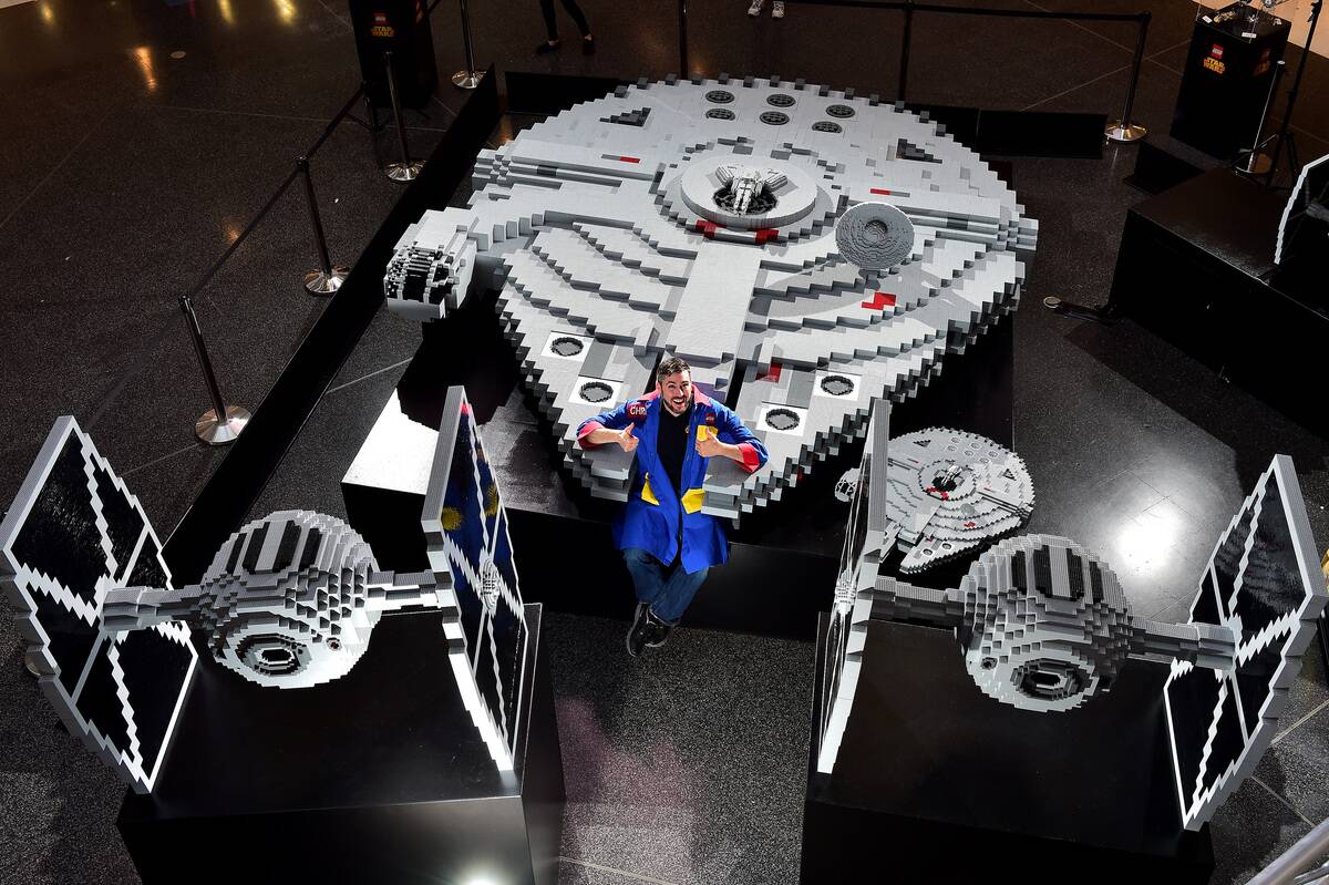 Lego Master Builder Chris Steininger Poses With The Millennium Falcon