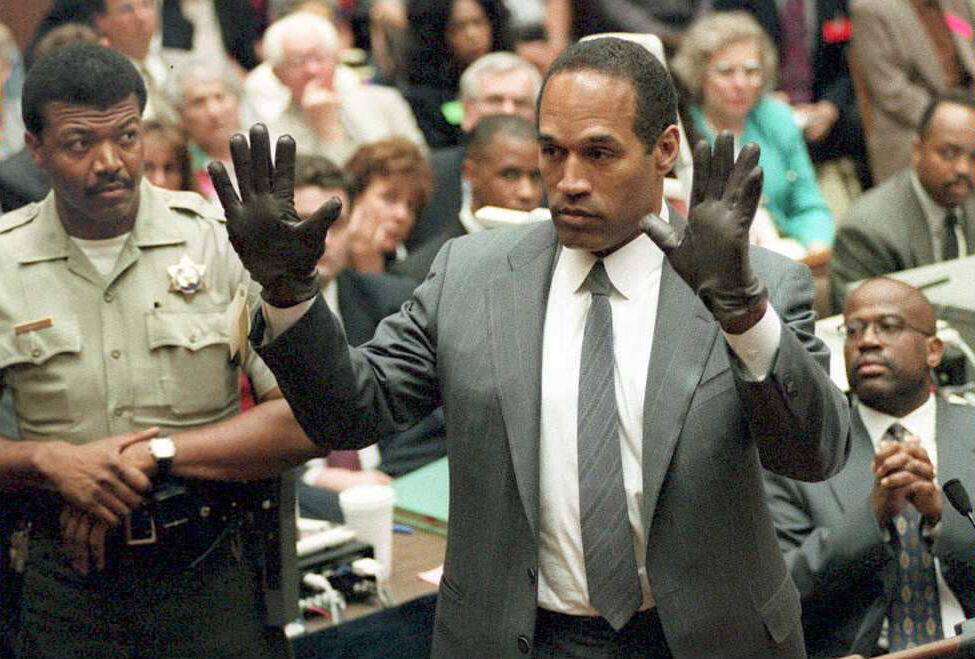 O.J. Simpson shows the jury a new pair of Aris ext