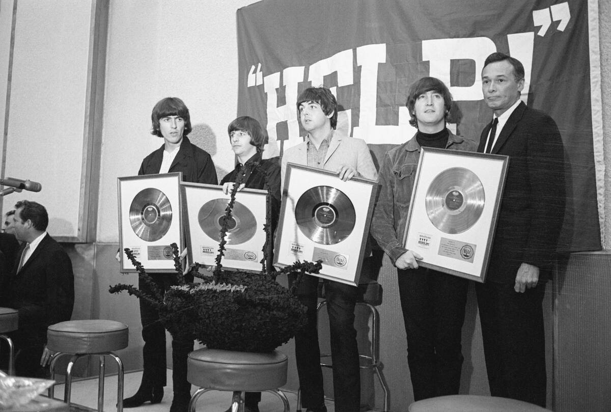 The Beatles Holding Gold Records