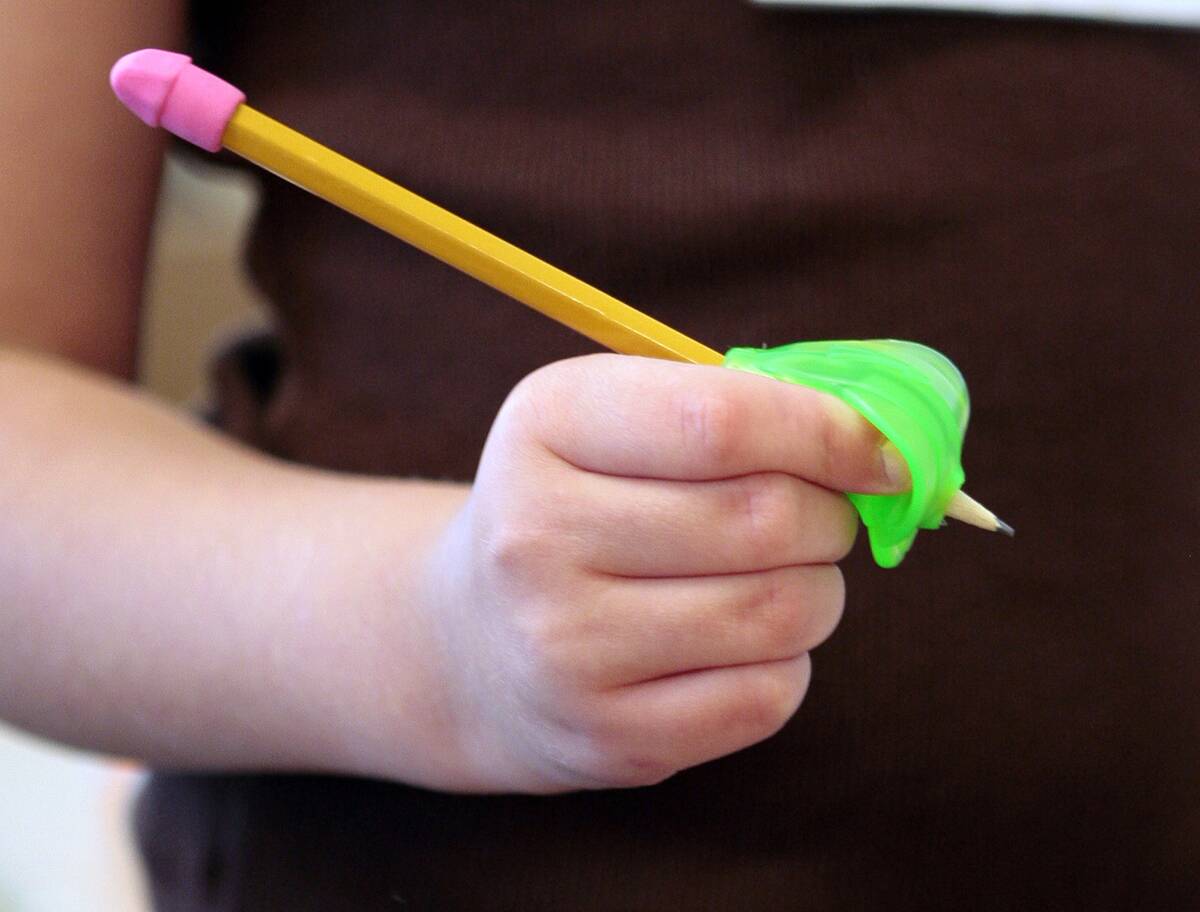 Third grader Alissa Kruszenski tries out a pencil grip handed out Tuesday, September 18, 2007 at Ken