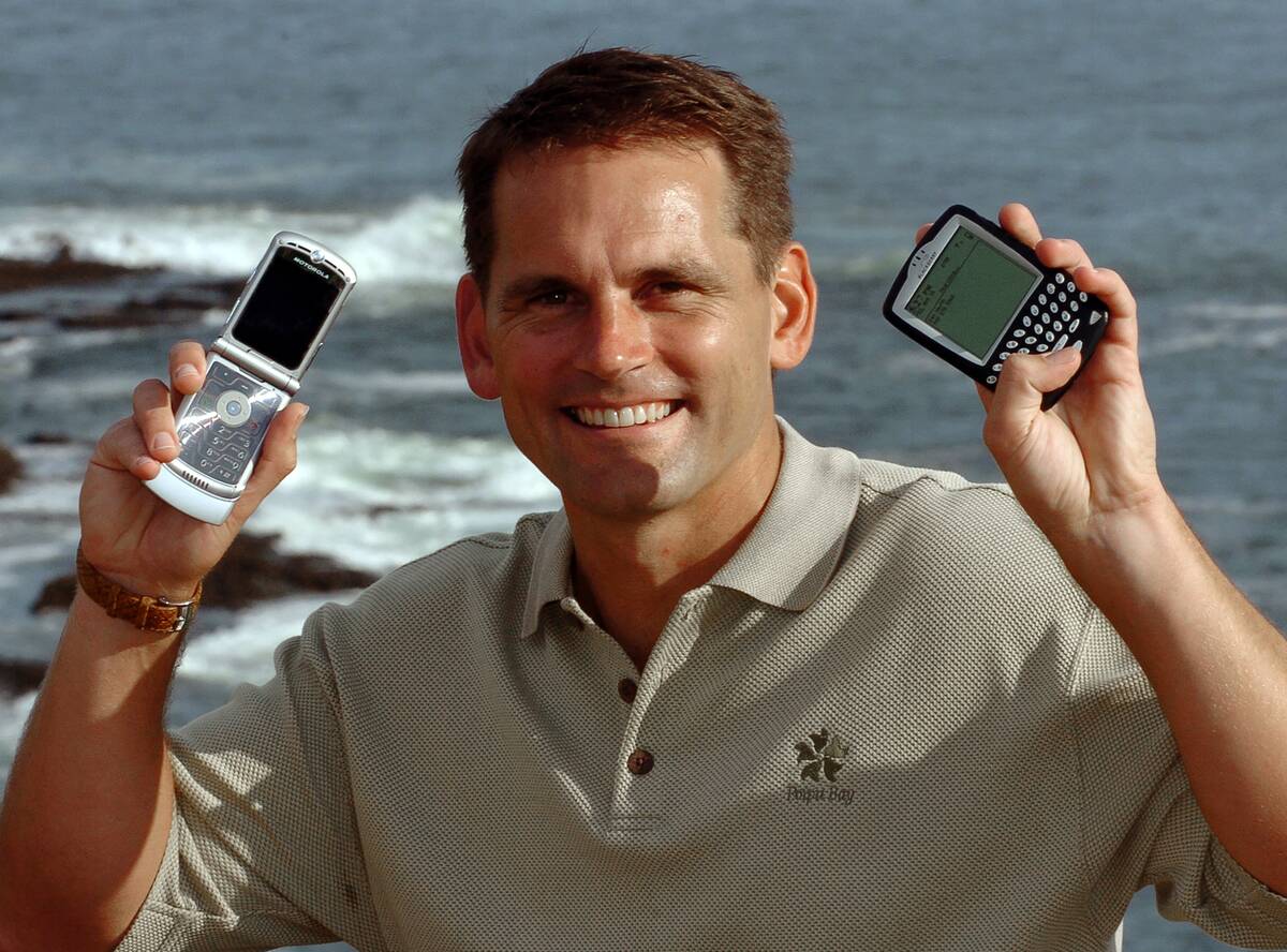Traveler Uses Cellphone And BlackBerry