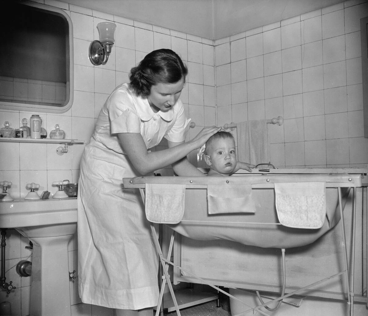 Woman Giving Baby a Bath, circa 1937