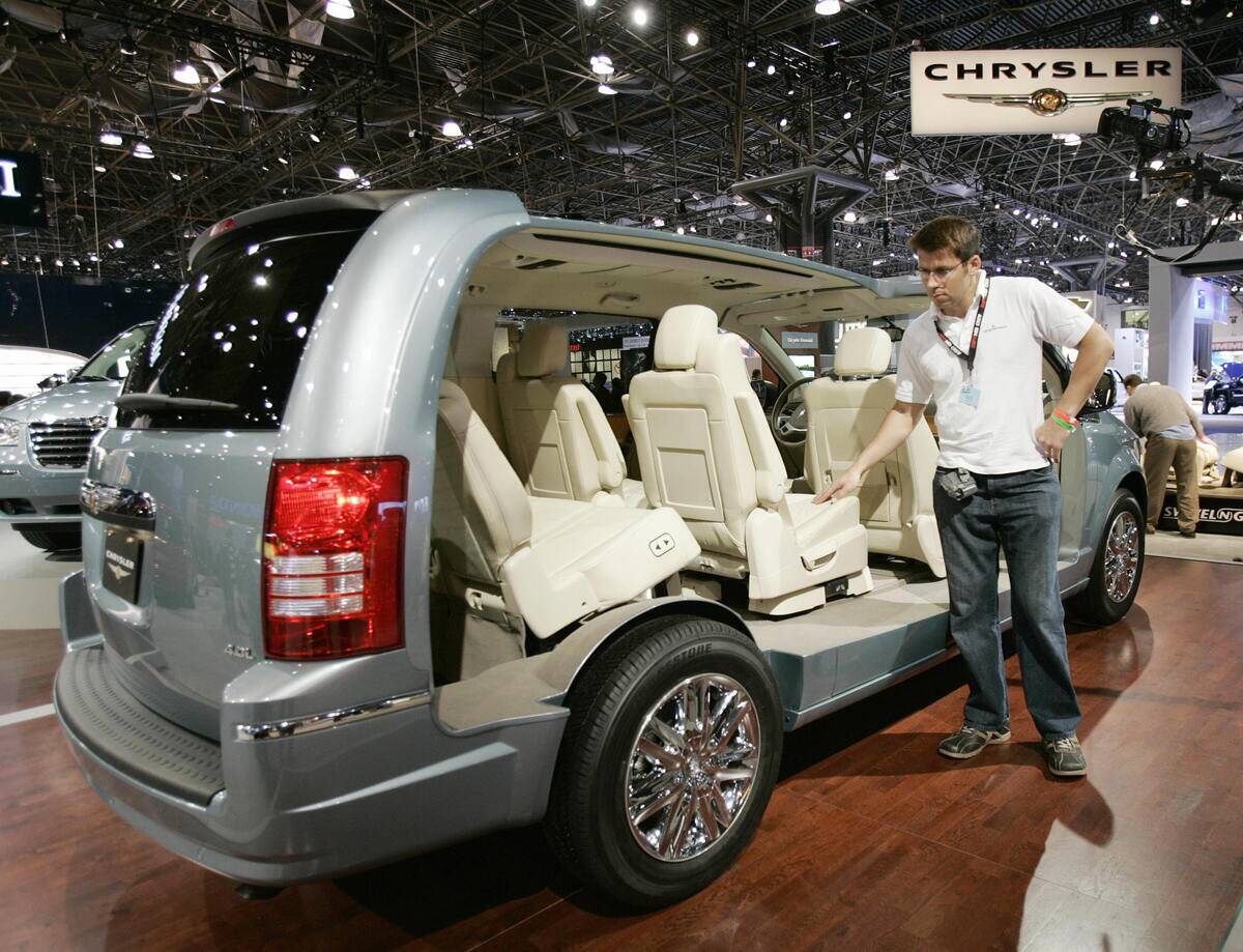 A man looks at a Chrysler Town and Count