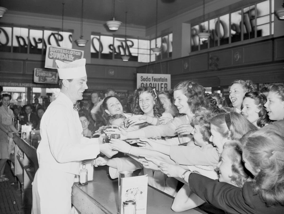 Actor Dana Andrews Serving Sodas to Fans