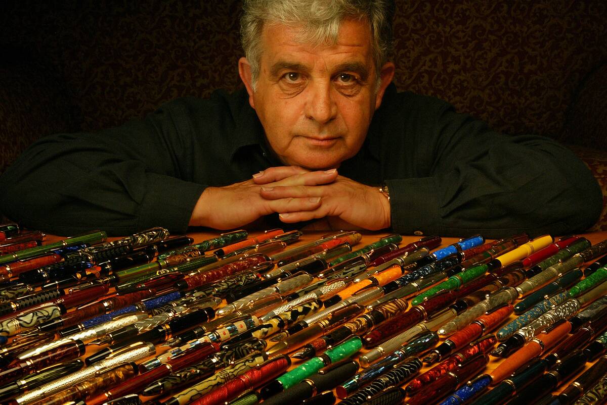 Andreas Lambrou, a fountain pen collector and president of Classic Pens Inc., posing with a group of