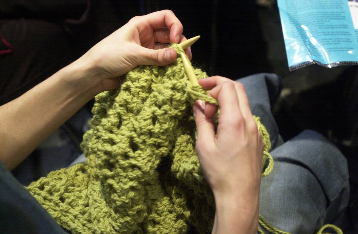 Brooke Moreno is knitting a shawl at the knitting circle held Monday nights at Casco Bay Books, Port