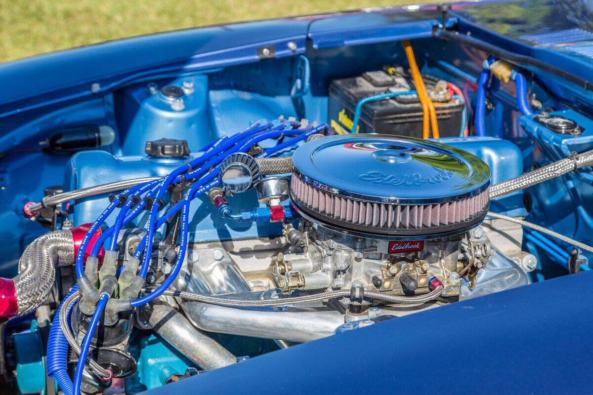 Clean engine with Edelbrock carburetor and breather in restored classic muscle car