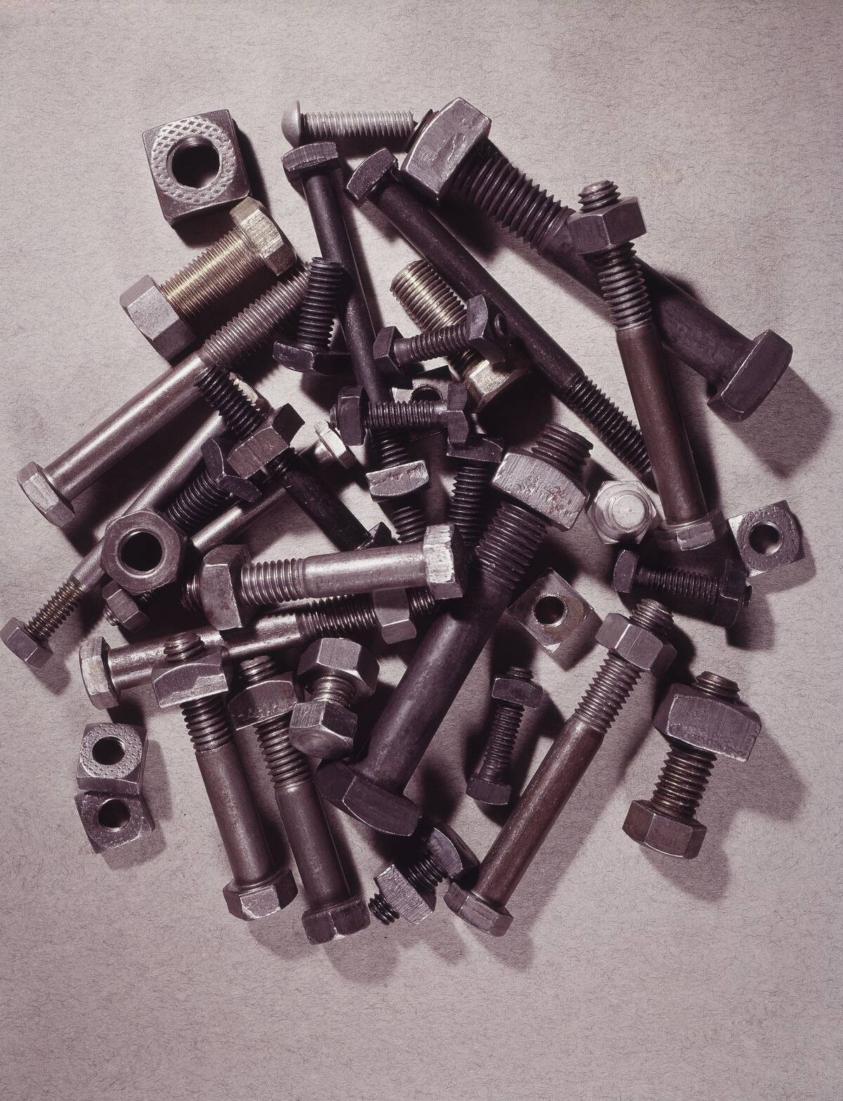 CLOSE-UP OF RUSTY NUTS AND BOLTS