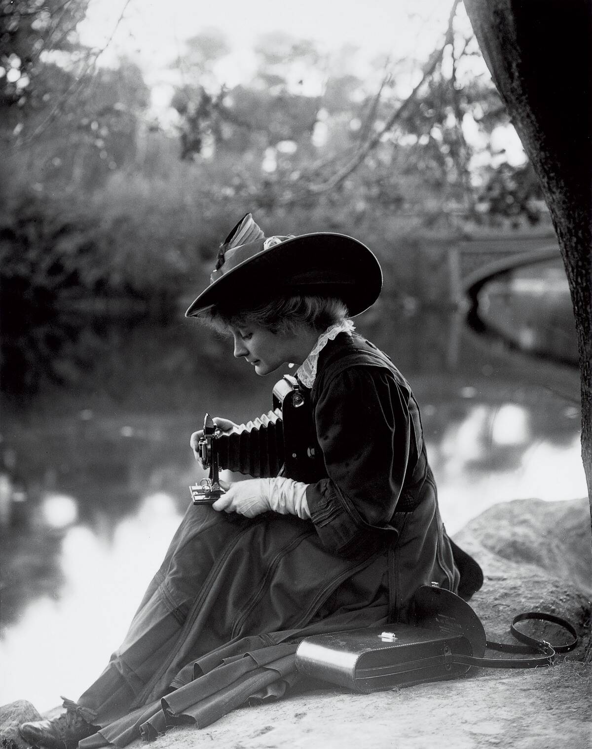 Demonstrating the portable Kodak 4A folding camera, c 1900.