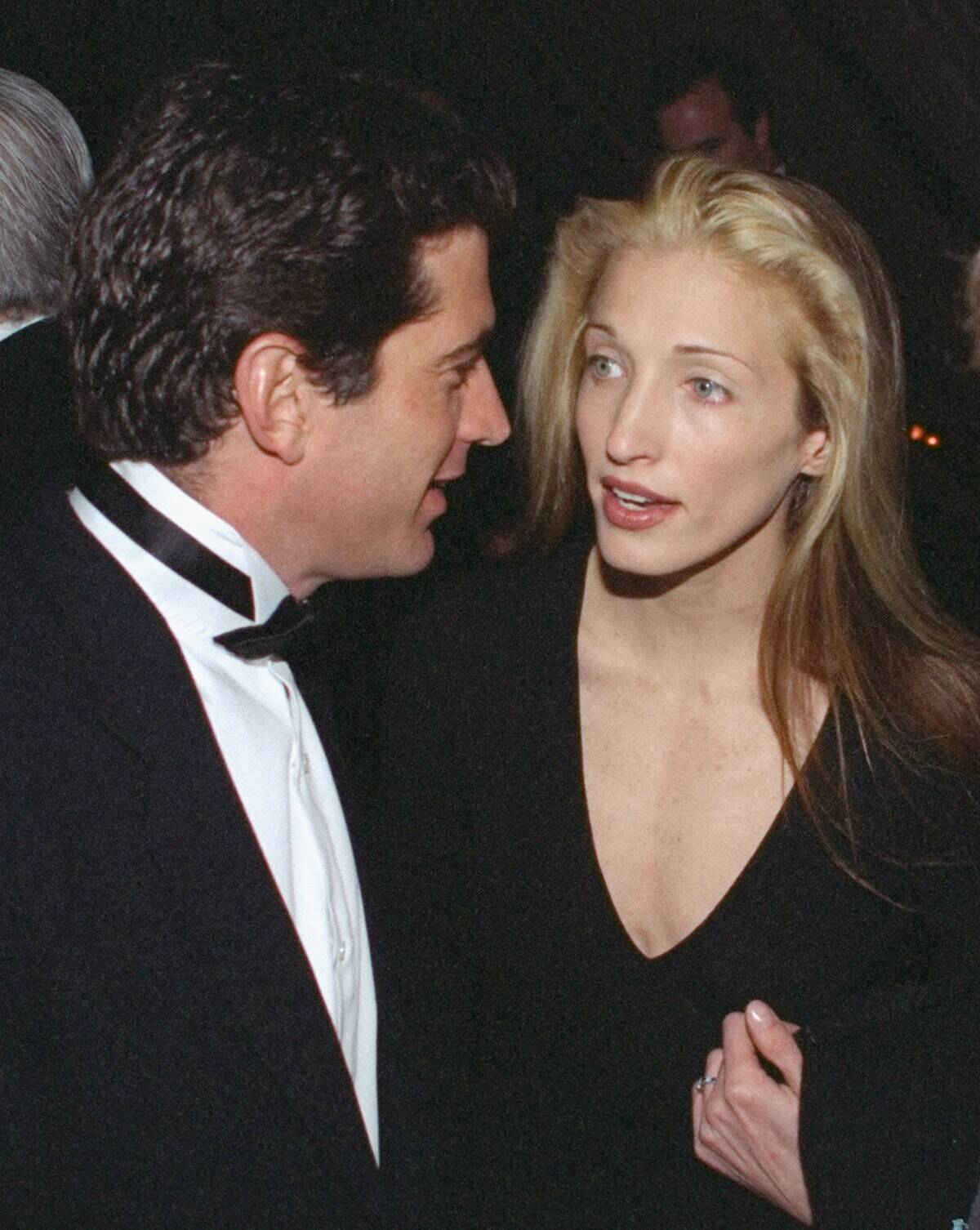 John F. Kennedy Jr. chats with his girlfriend, Carolyn Besse