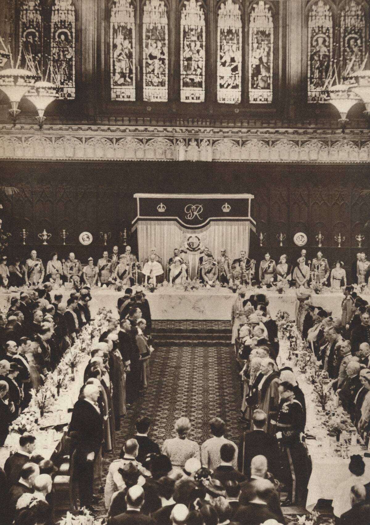 'King George VI and Queen Elizabeth attending a luncheon to celebrate coronation', 1937