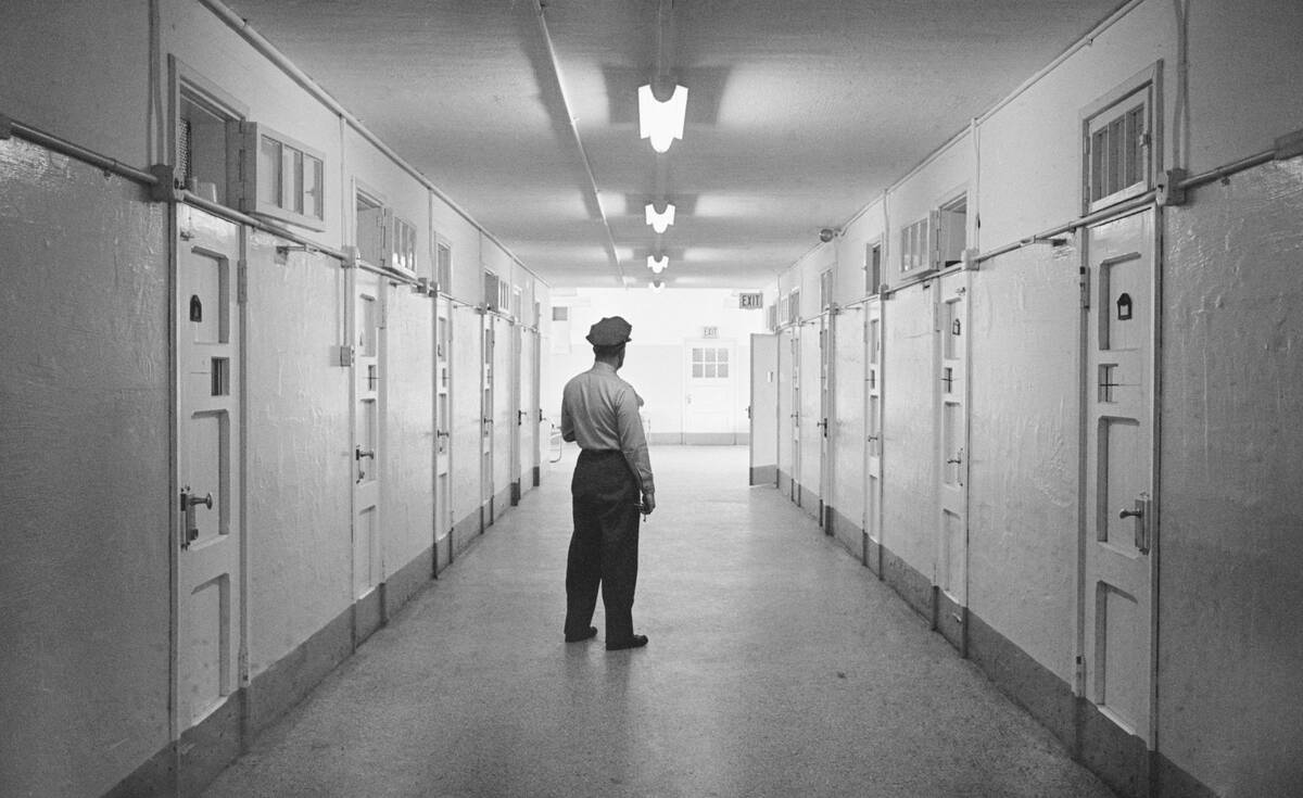 Officer Standing in Hallway of Prison