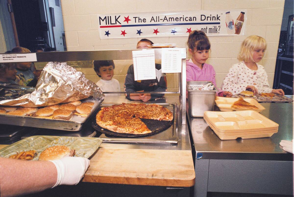 Students Eat Lunch In The School Cafeteria