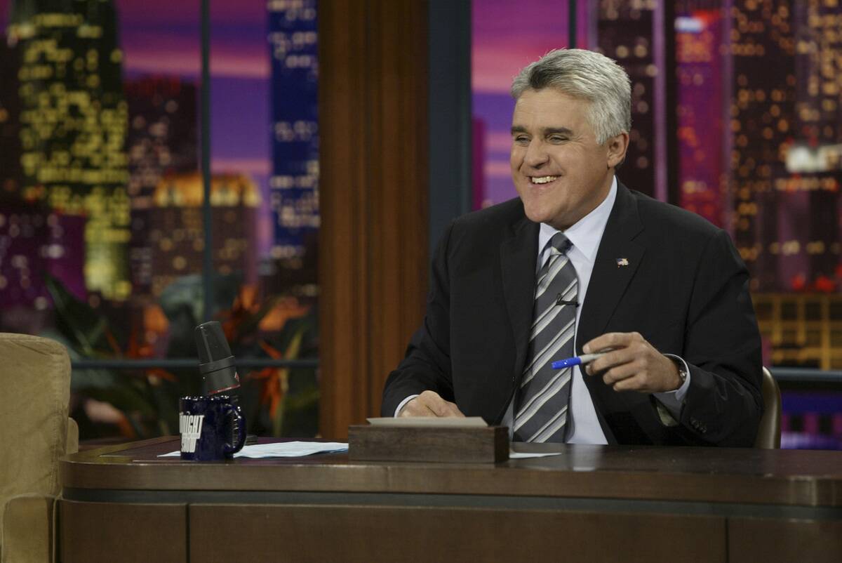 jay leno smiling at desk, hosting tonight show