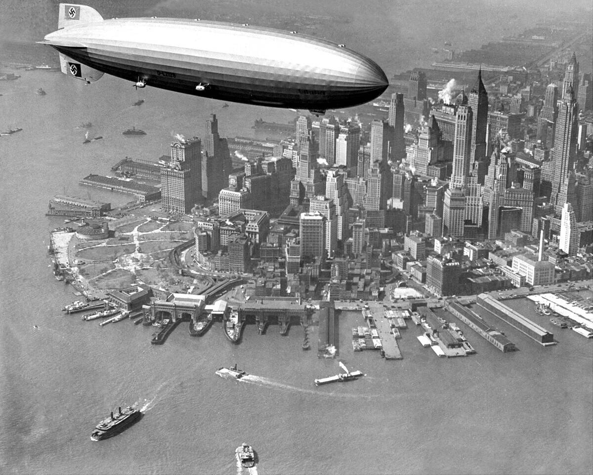 The zepplin Hindenburg flies over Manhattan.