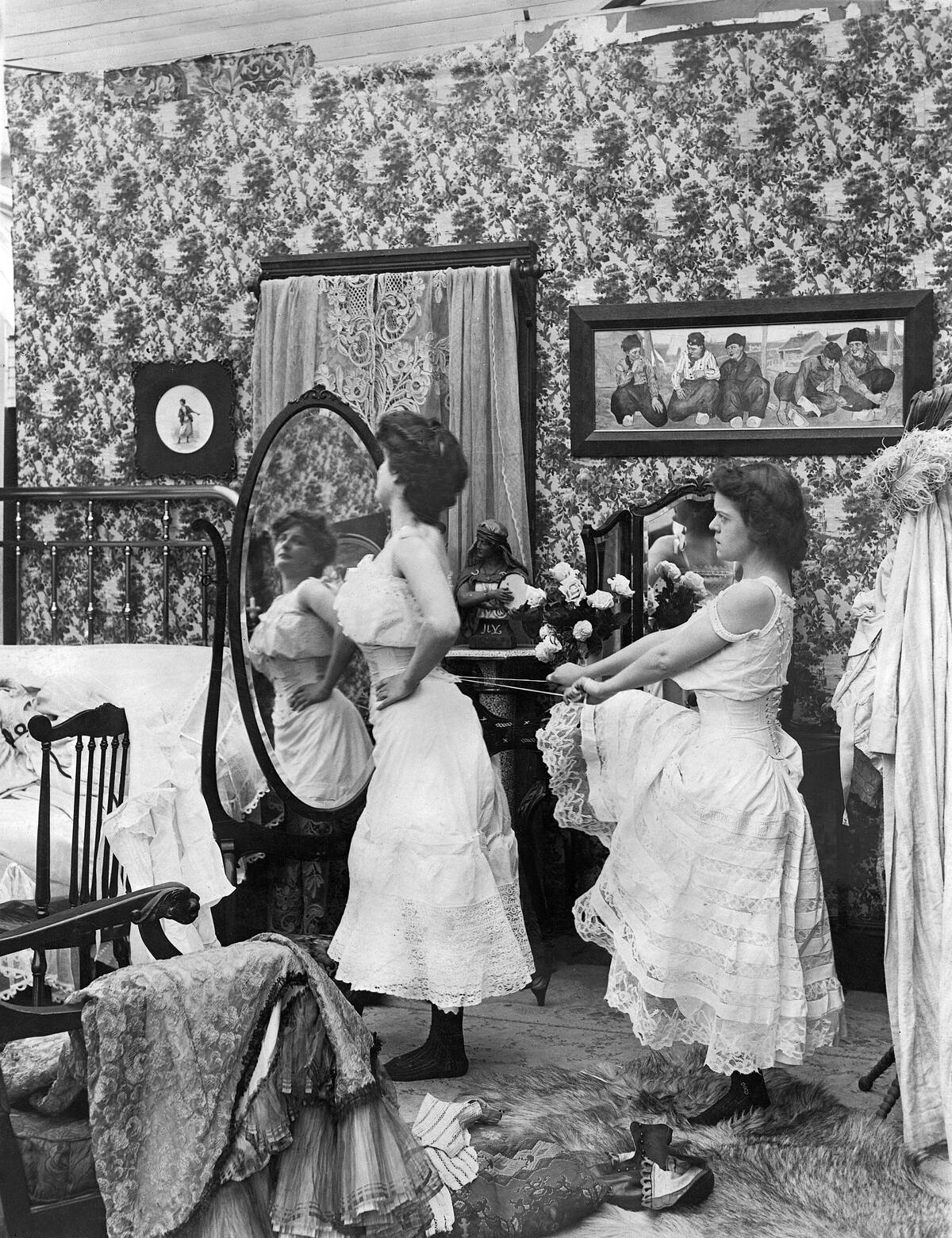 Woman Lacing Up Woman's Corset