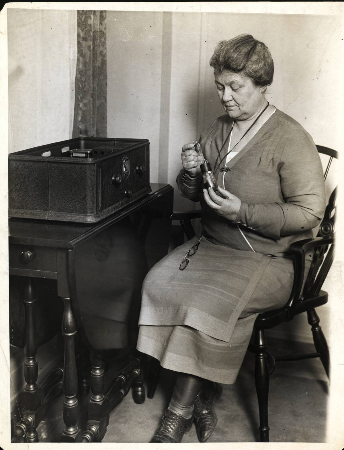 Woman Repairs Vacuum Tube For Radio