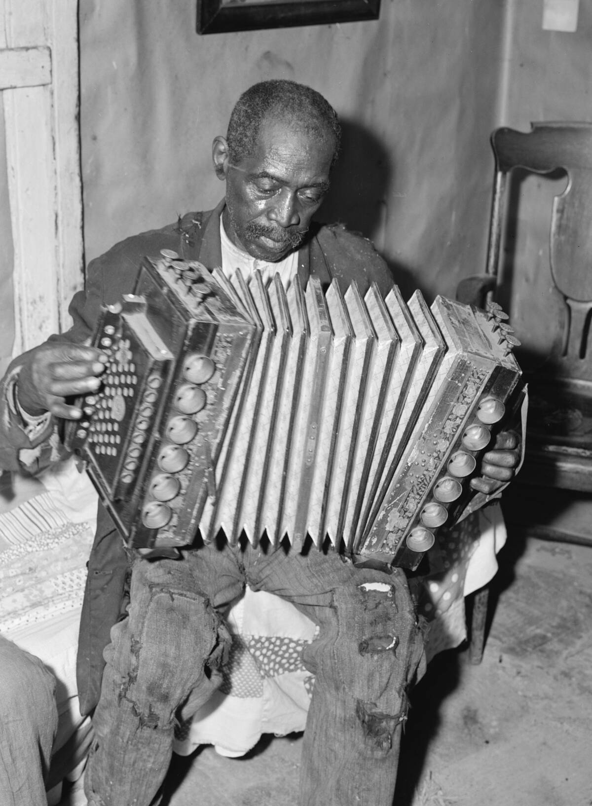 African American Mr. Dyson, aged FSA borrower plays the accordion.