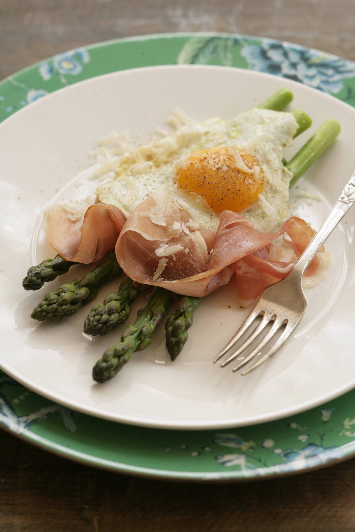 Asparagus with prosciutto, egg and parmesan. Recipe by Jill Dupleix meal, fork