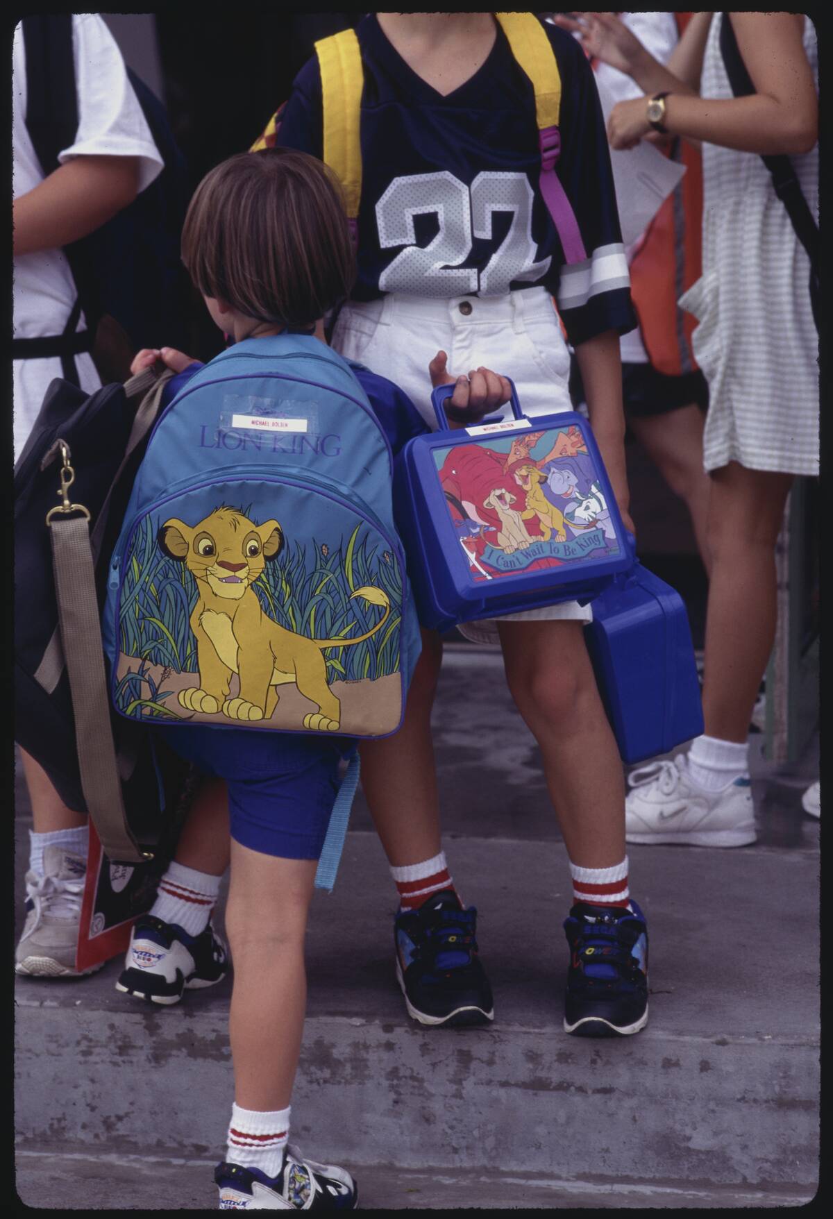 Child with Backpack and Lunchbox of Disney Characters