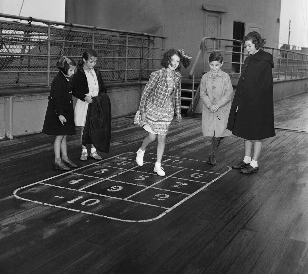 Girls (6-7) playing hop-scotch