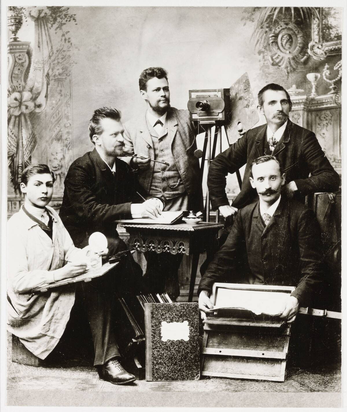Group of photographers and assistants with equipment, 19th century.