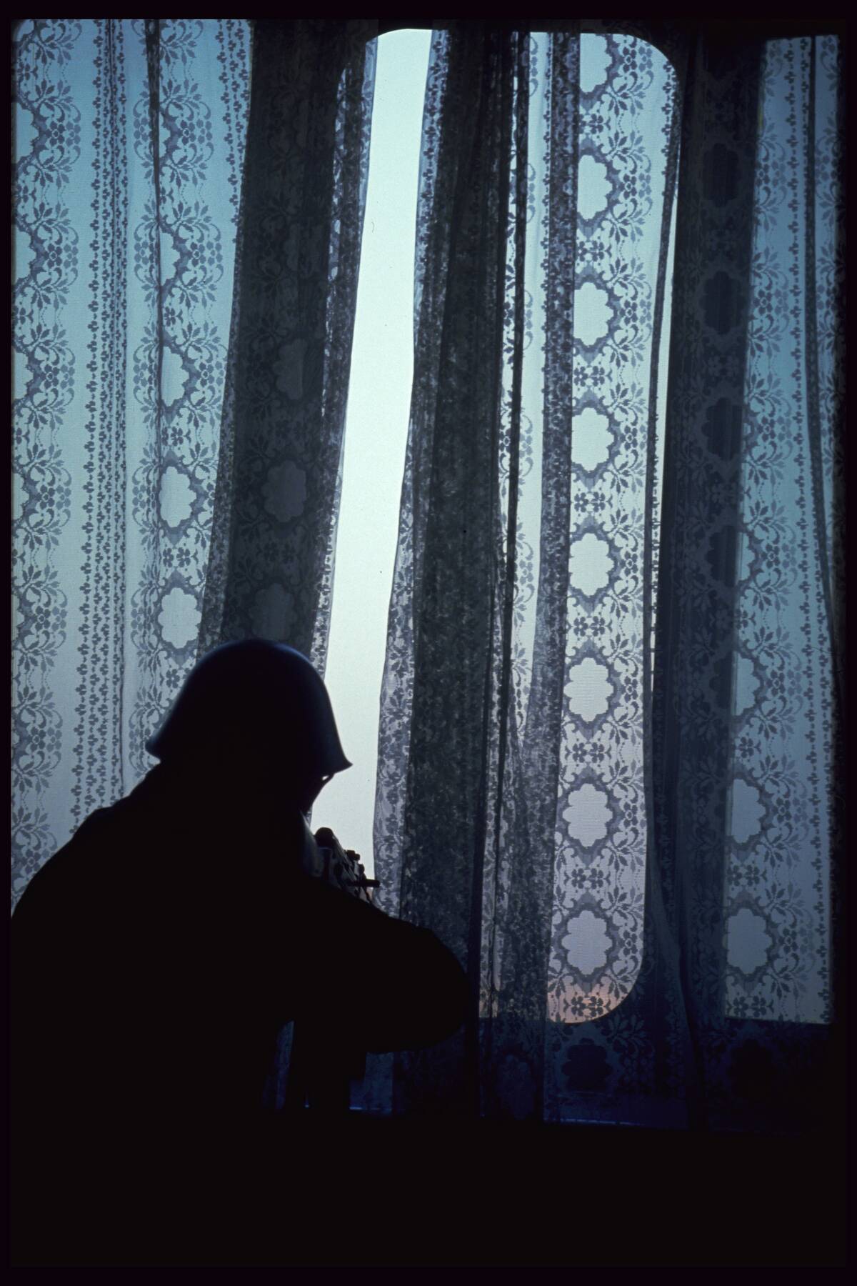 Rebel Romanian Soldier Hiding Behind Curtain
