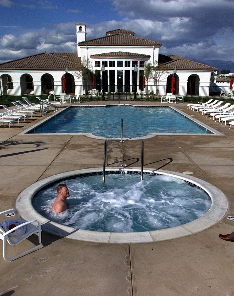 Rick Jackson, sits in a hot tub in one of the newest apartment complexes in Oxnard, the Tierra Vista