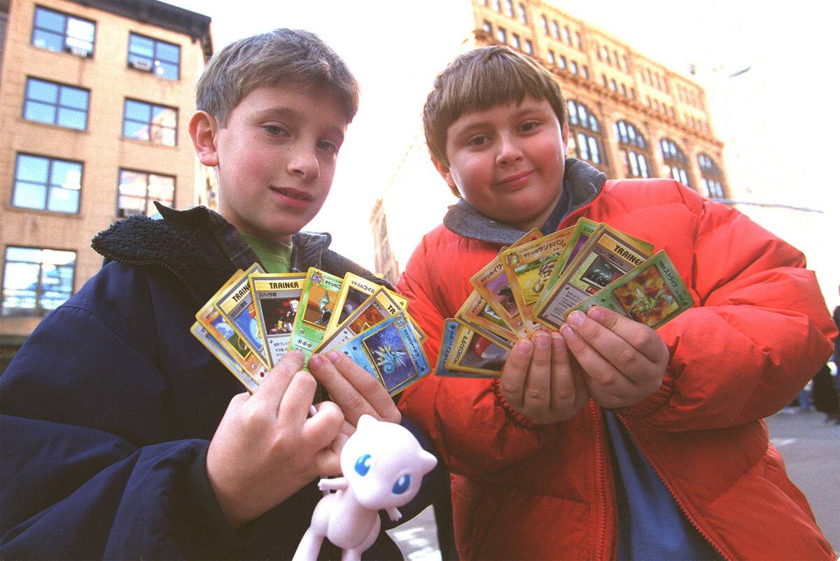 Two children display their Pokemon cards