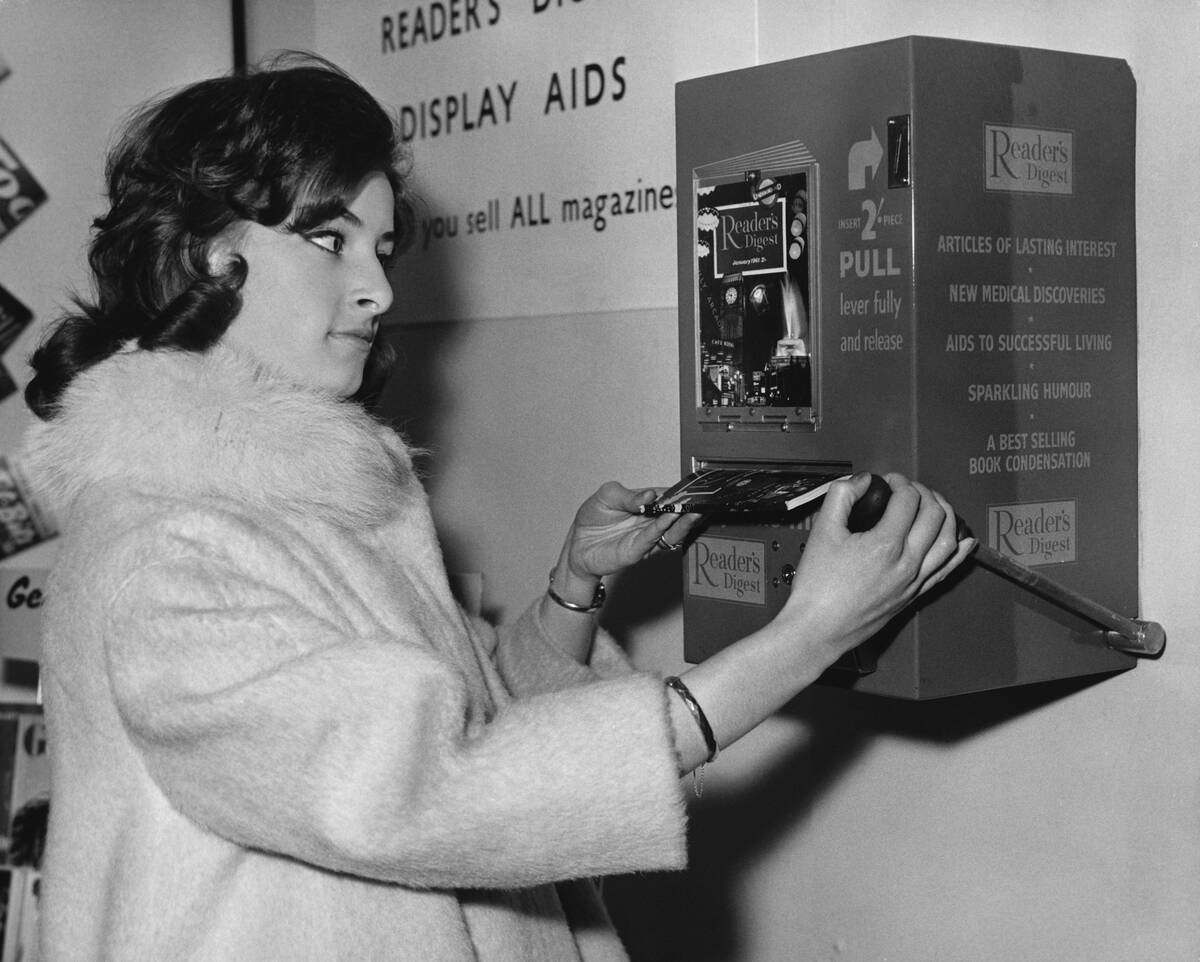 Woman Buys Book from Dispenser