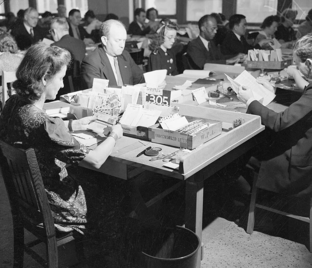 Worker In Post Office Inspects Envelopes